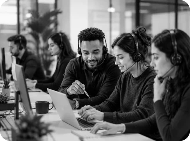 Customer operations team working together at a support desk
